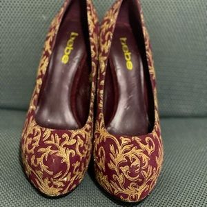 Bebe Glam Burgundy suede platform pumps. 5” heels with a 2” Platform.